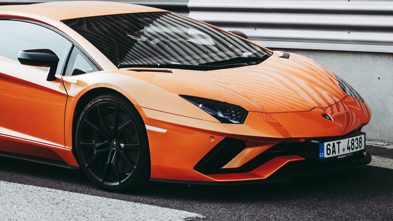 ports_car_side_view_orange_stylish_120195_1280x720.jpg