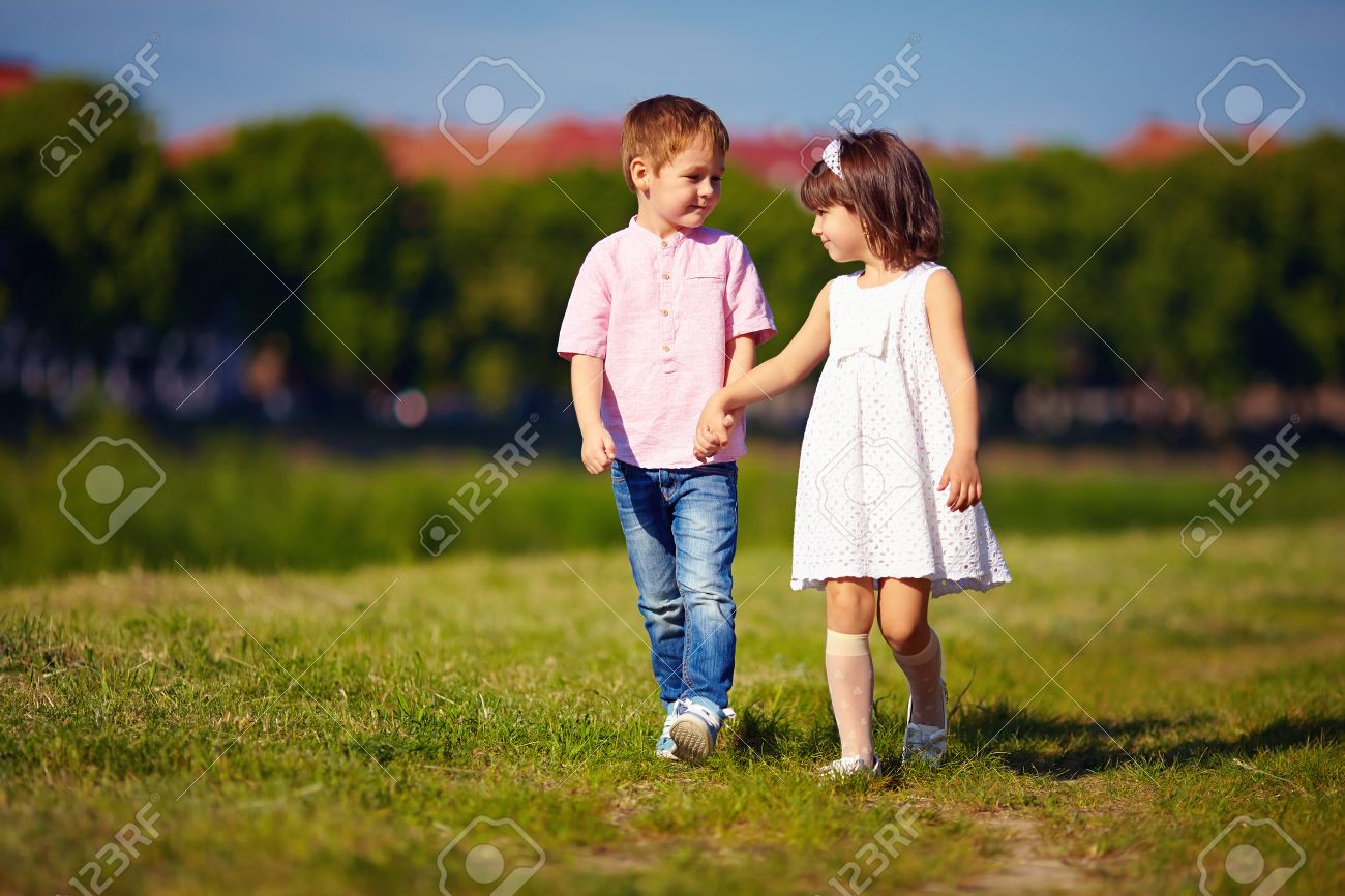 46329745-cute-kids-couple-walking-on-summer-field.jpg